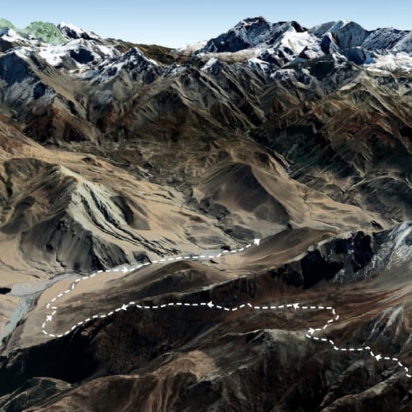 Photo of mountain range with a dotted line cutting through it, indicating a path.