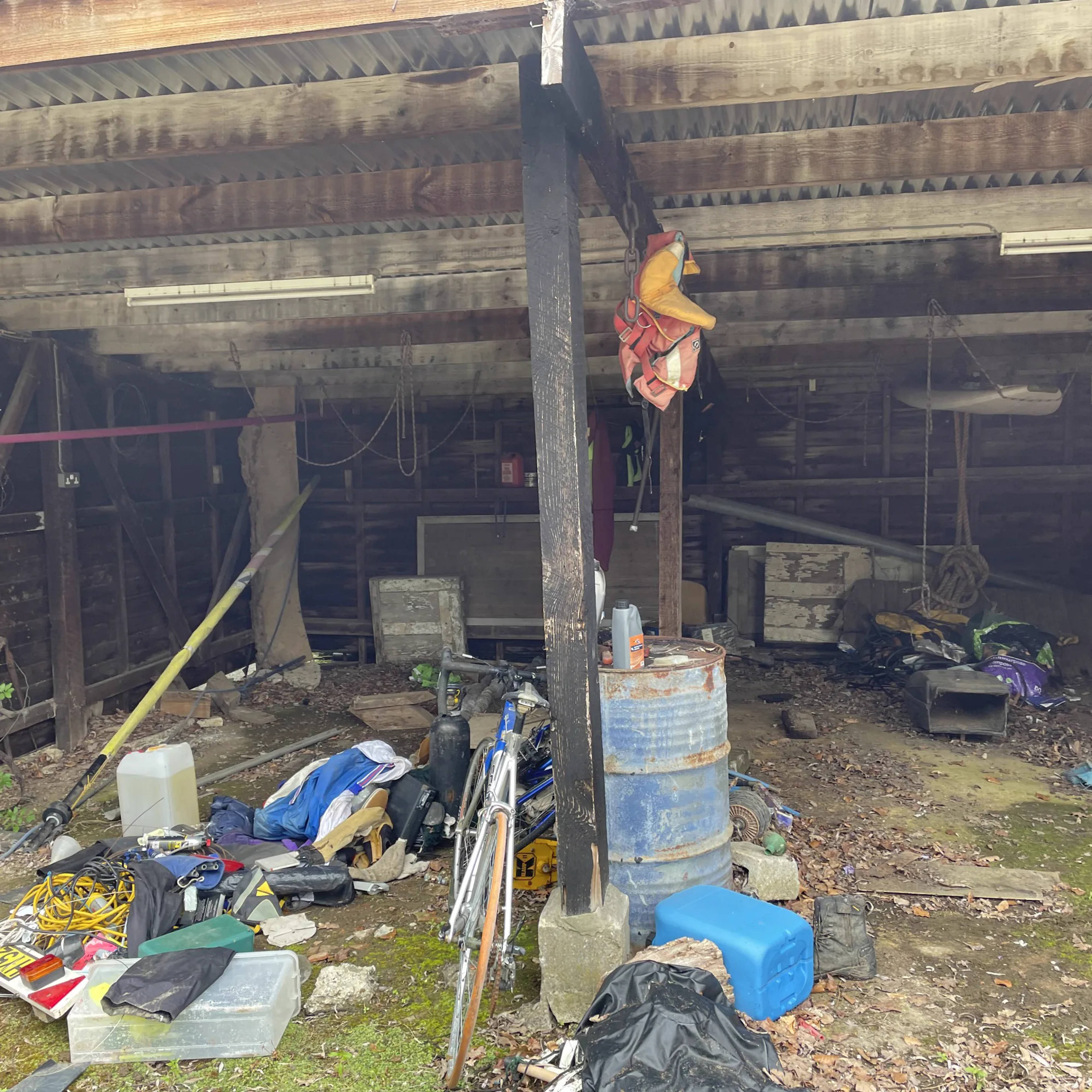 A cluttered barn full of accumulated items before a clearance