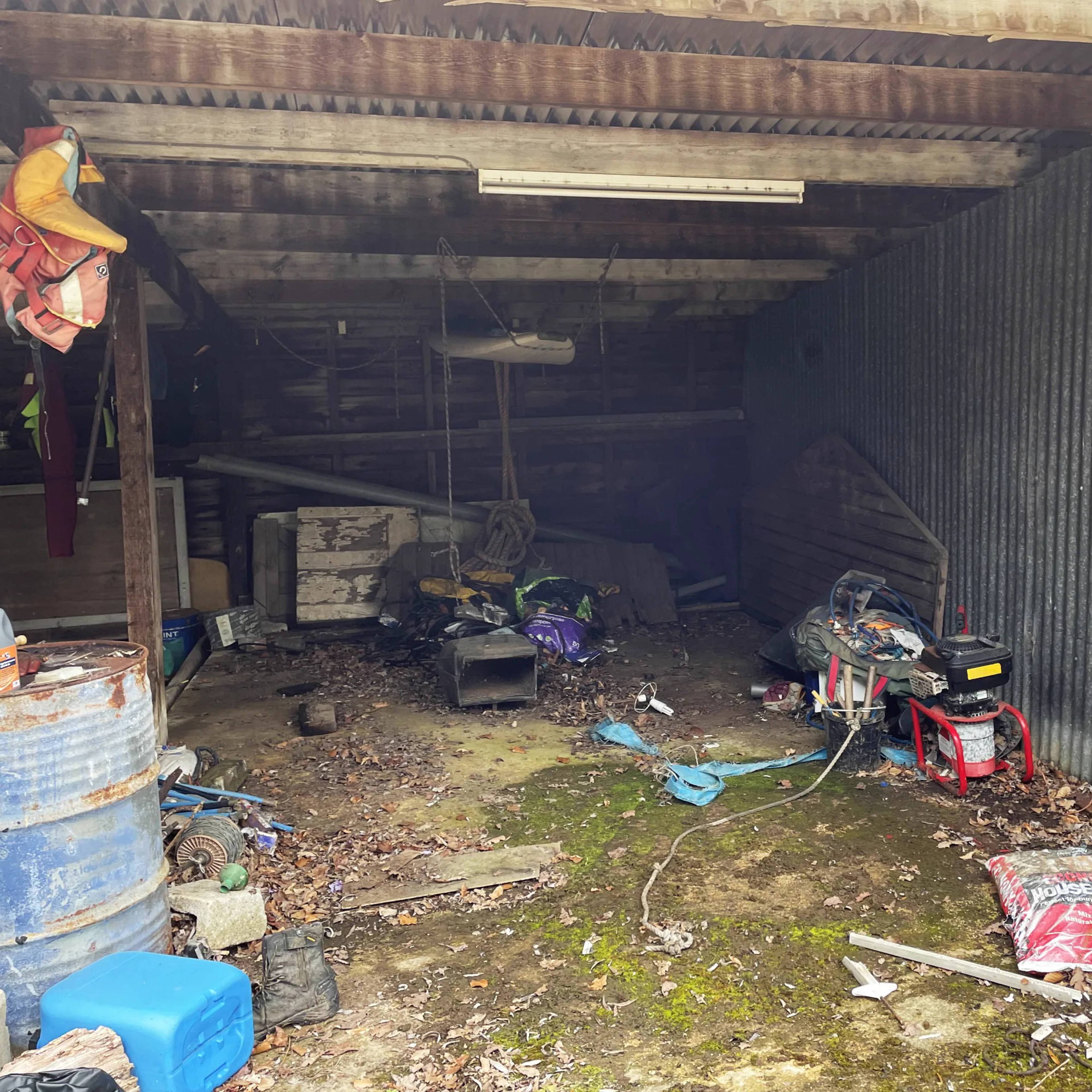 An outbuilding packed with old equipment before a house clearance
