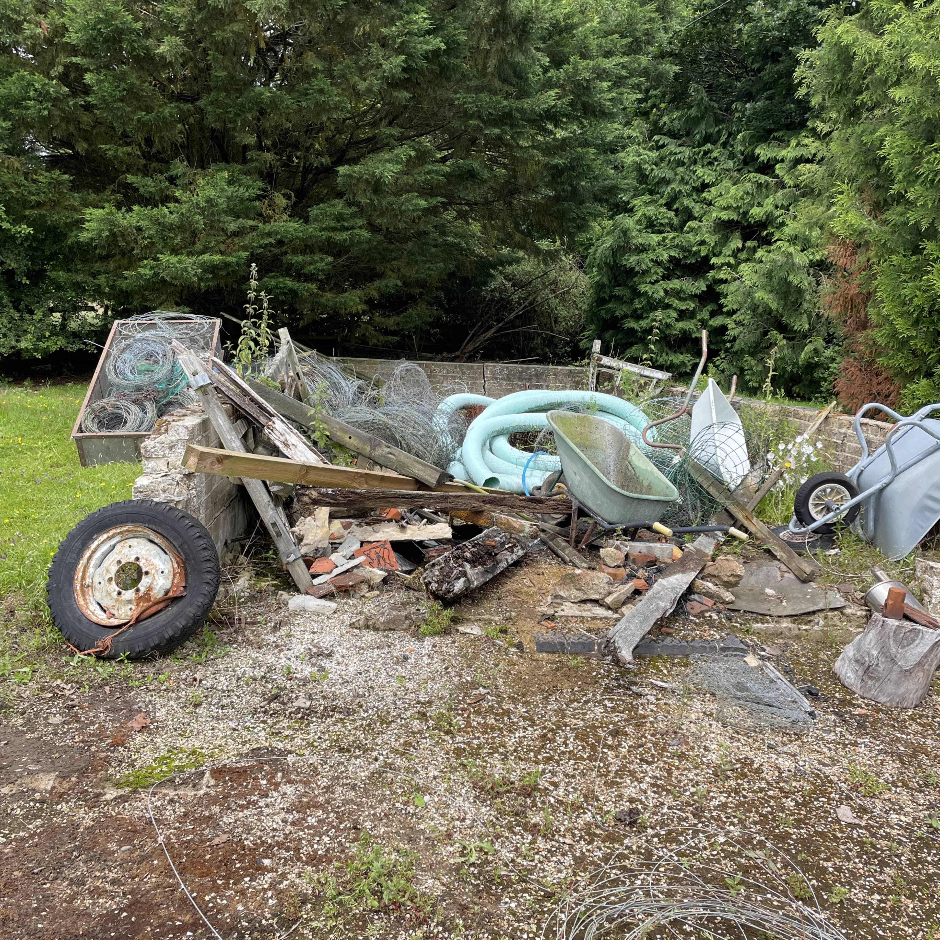 Garden waste, scrap and rubbish gathered for removal from a property