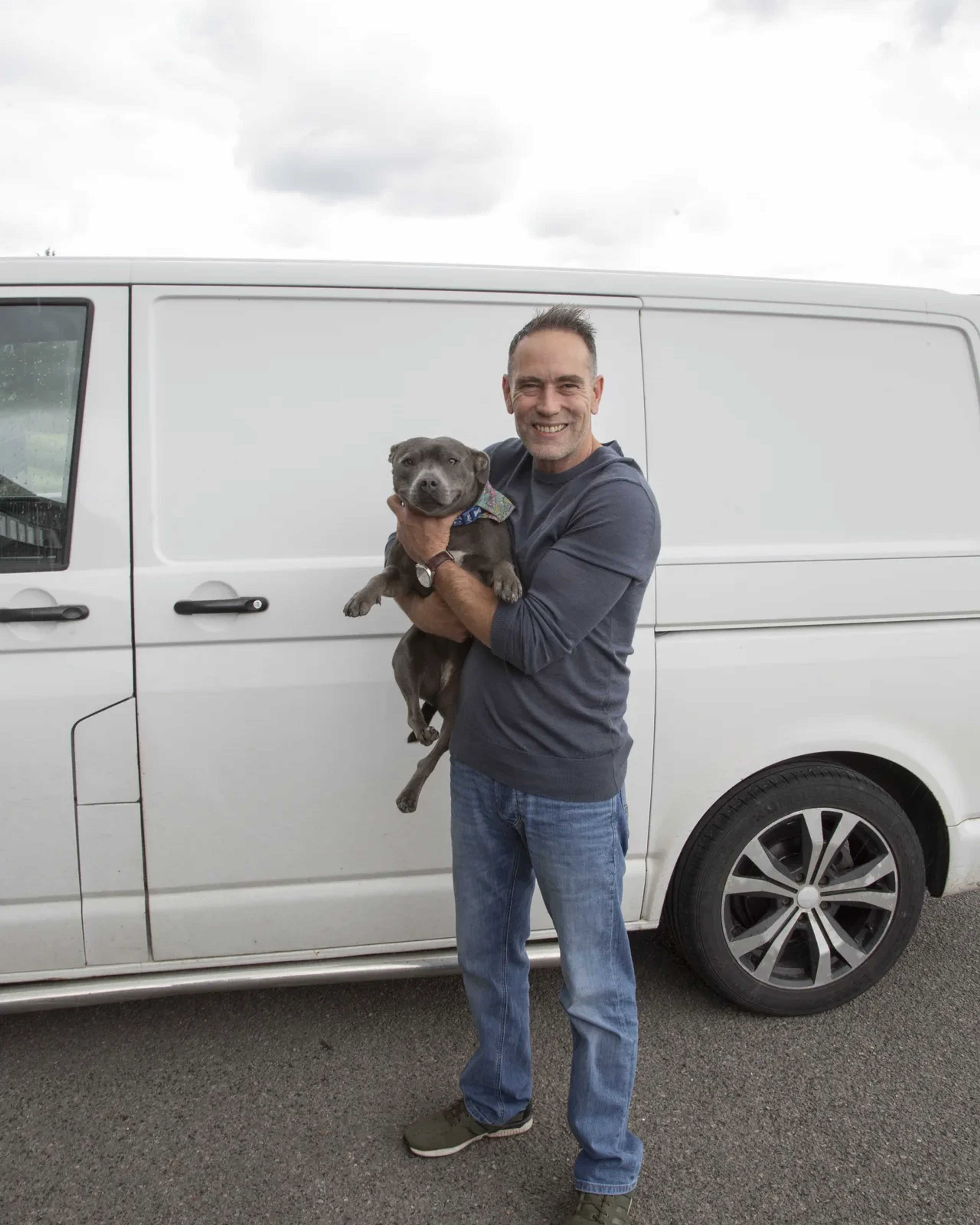 Wayne Ross, owner of Clear House Moves, with his dog beside a company removal van