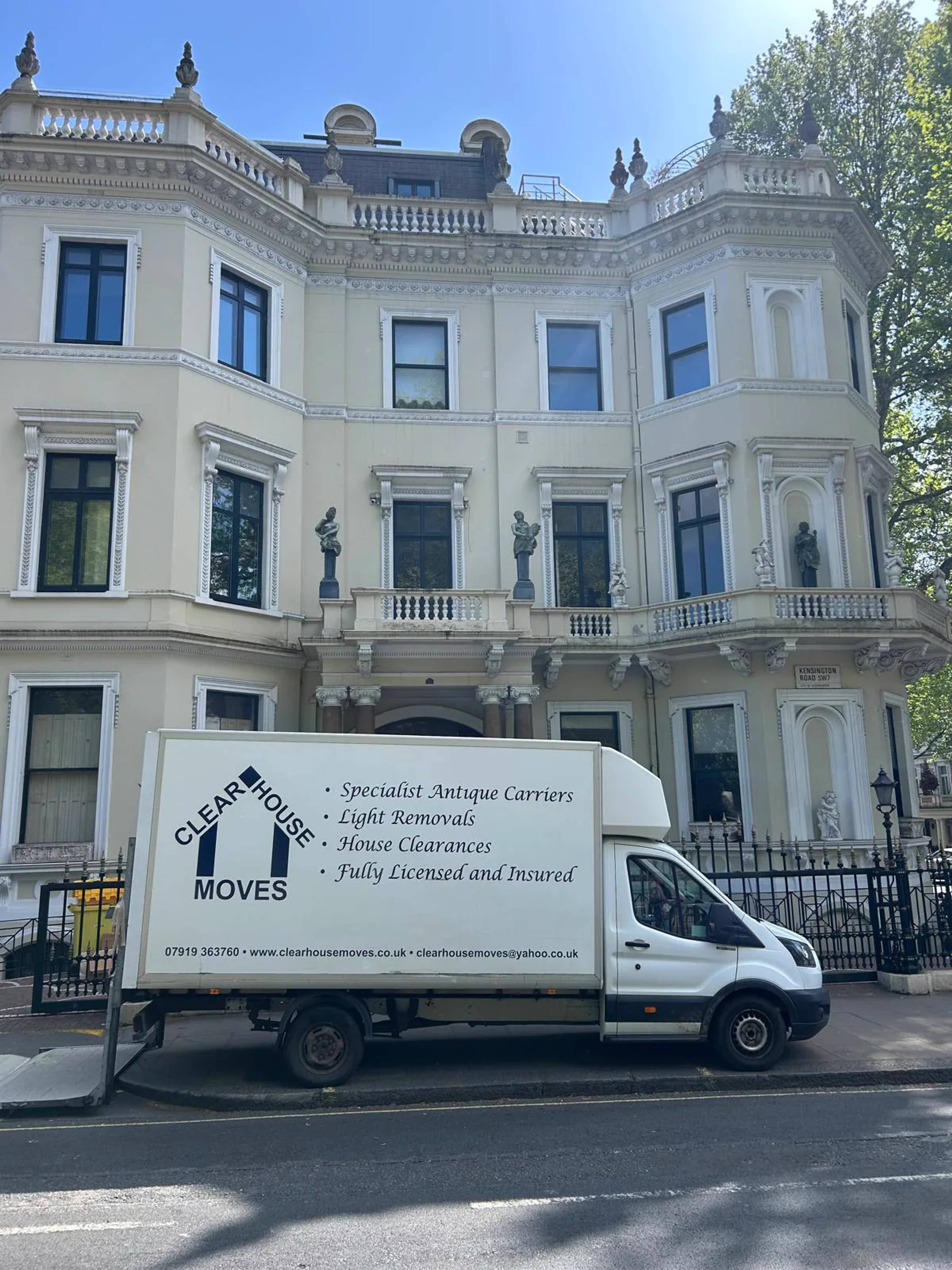 A Clear House Moves van outside a period London townhouse under a blue sky