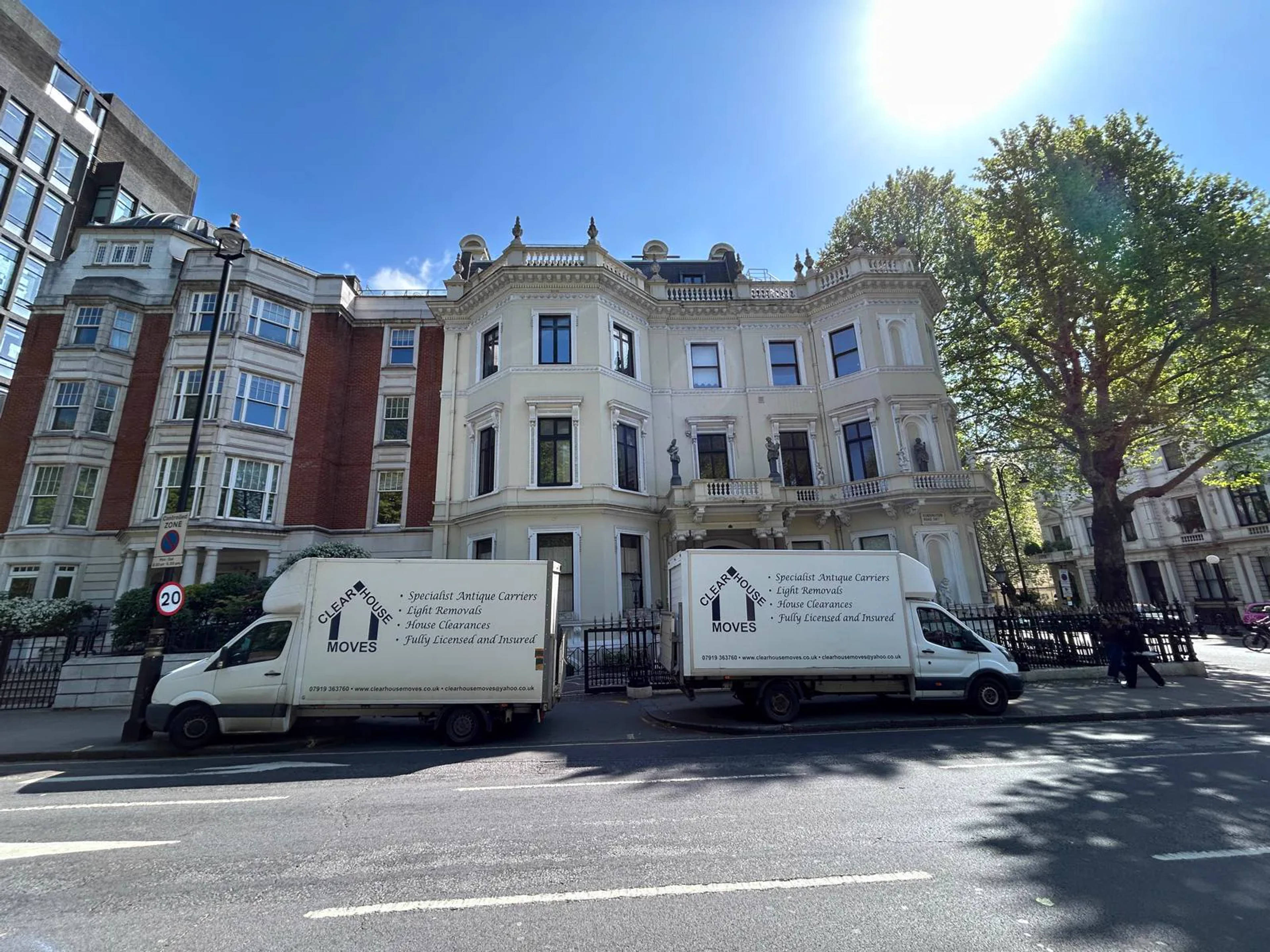 Two Clear House Moves removal vans parked outside a grand London townhouse on a sunny day