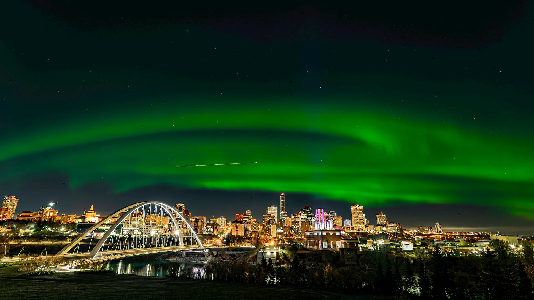 Edmonton's Walterdale Bridge and downtown skyline under the northern lights