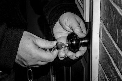 Locksmith turning a key in a door lock
