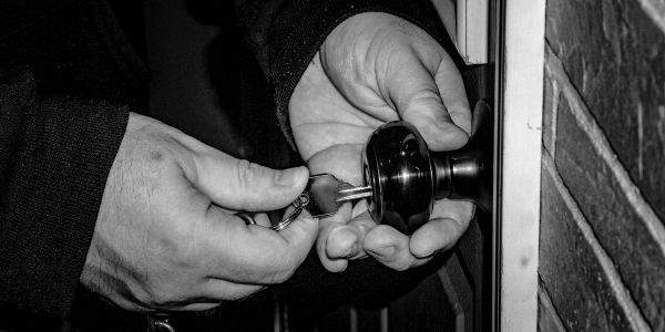 Locksmith turning a key in a door lock