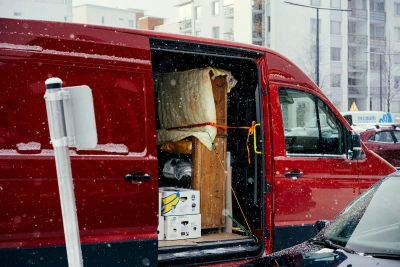 Moving van loaded with furniture and boxes on a snowy street