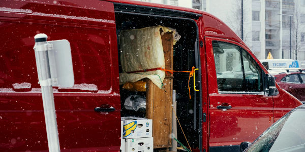 Moving van loaded with furniture and boxes on a snowy street