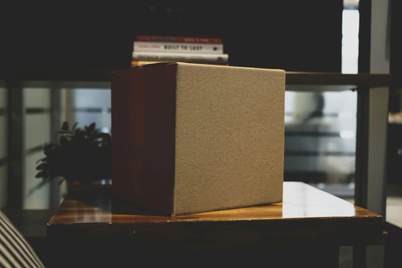 An empty cardboard box on a desk in an office