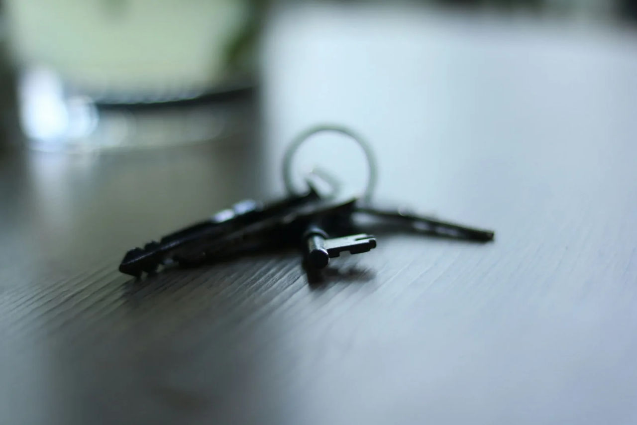 A set of house keys on a dark table