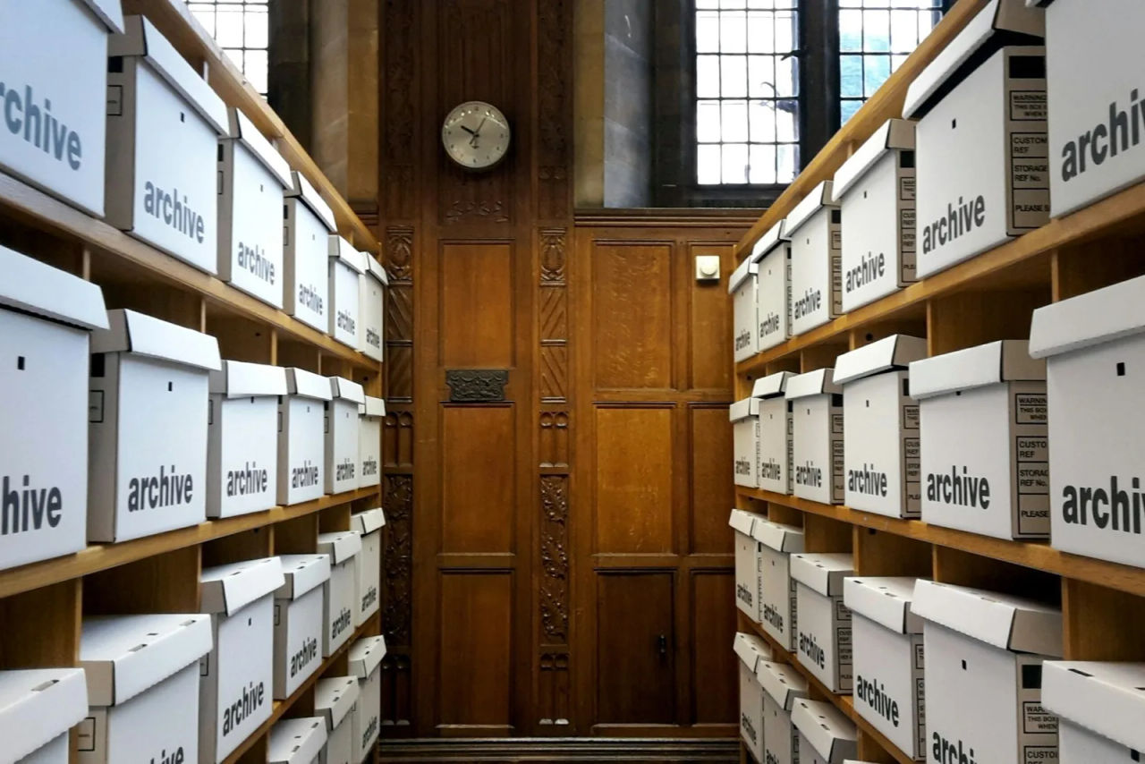 Shelves of labelled archive boxes in a records room