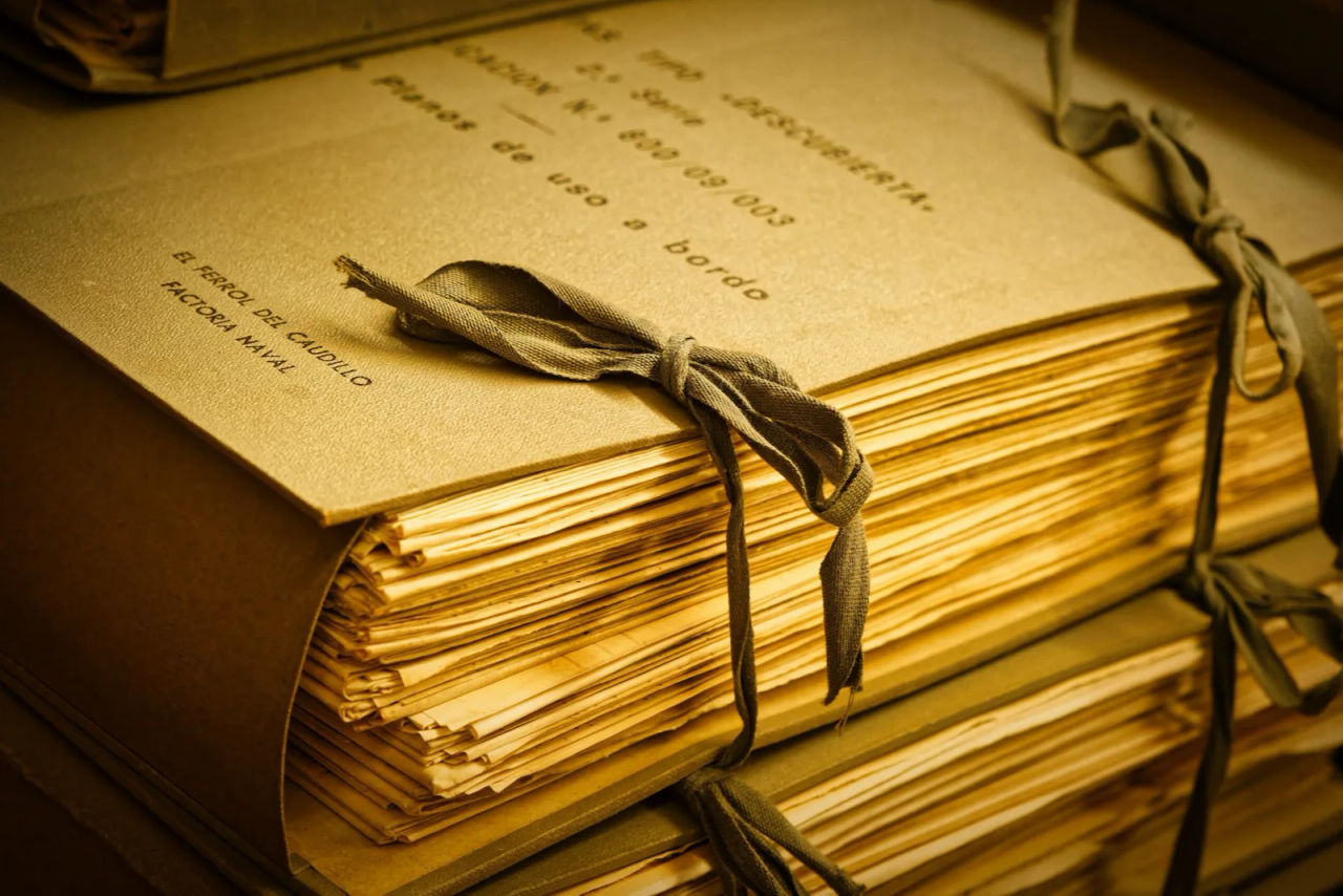 A stack of documents tied with a ribbon