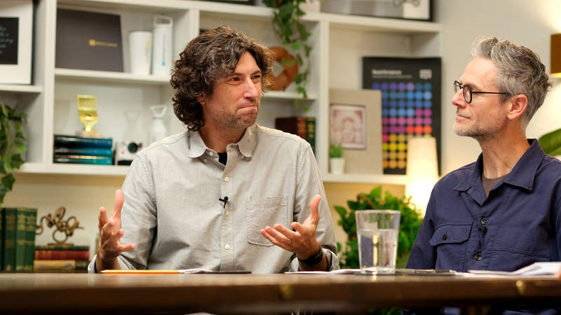 Tim and Jon talking at the Classroom table
