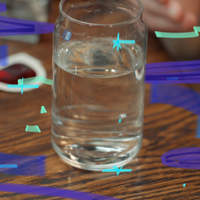 Photo of a clear glass of water on a wooden table with blue graphic accents.