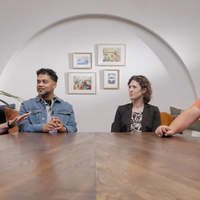 BibleProject scholars sitting at a table having a discussion.