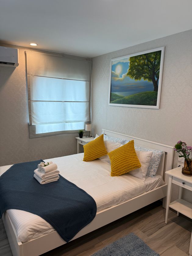 Bright bedroom with double bed and white bedding