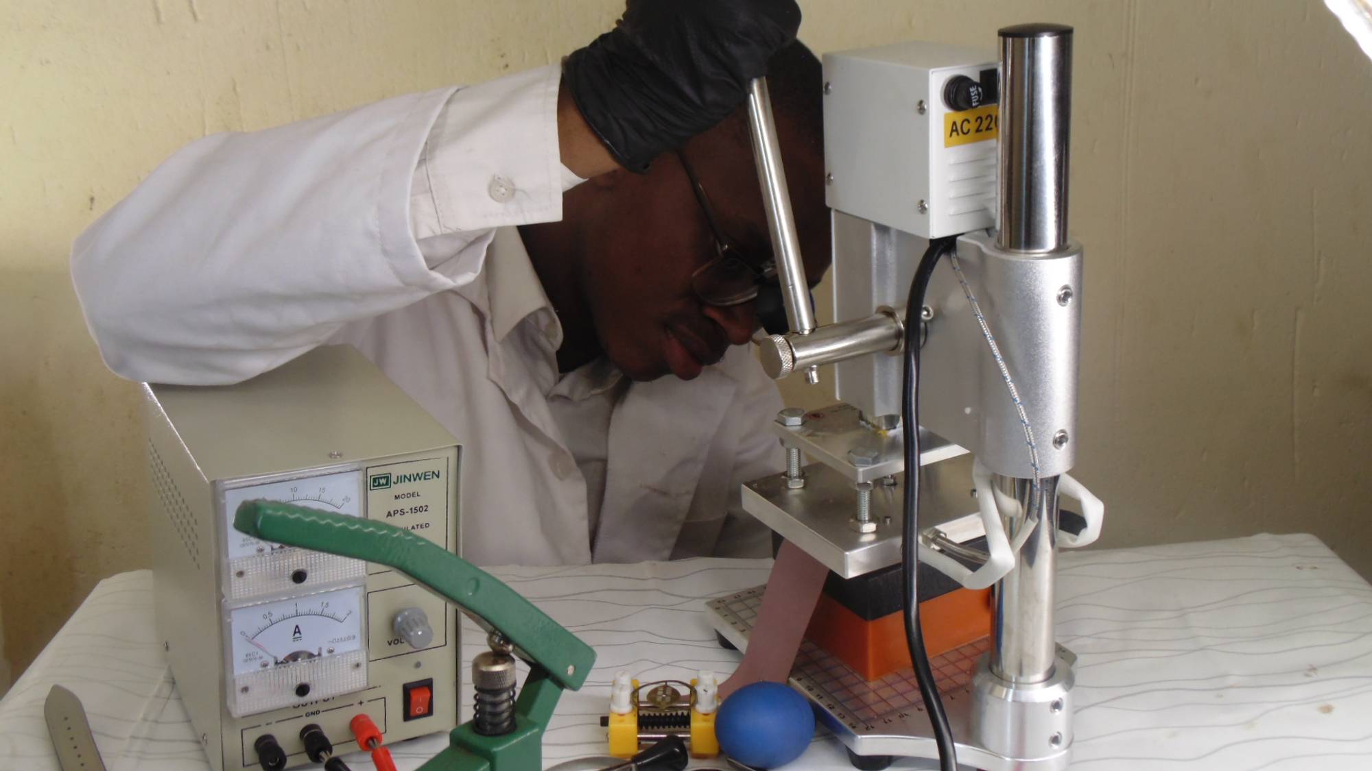 Sakhile pressing a watch case in the workshop