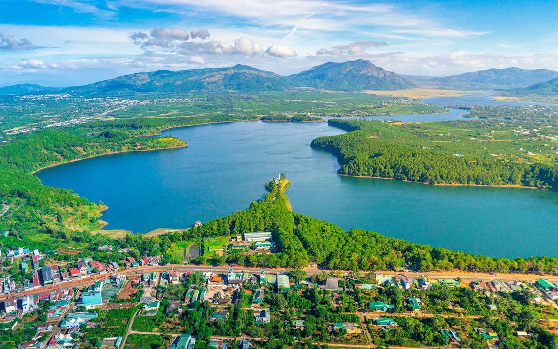 A panoramic view of Gia Lai highland city with Pleiku Lake curving through the forest