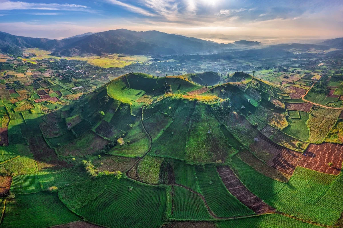 Aerial view of Chư Đăng Ya Volcano surrounded by green fields