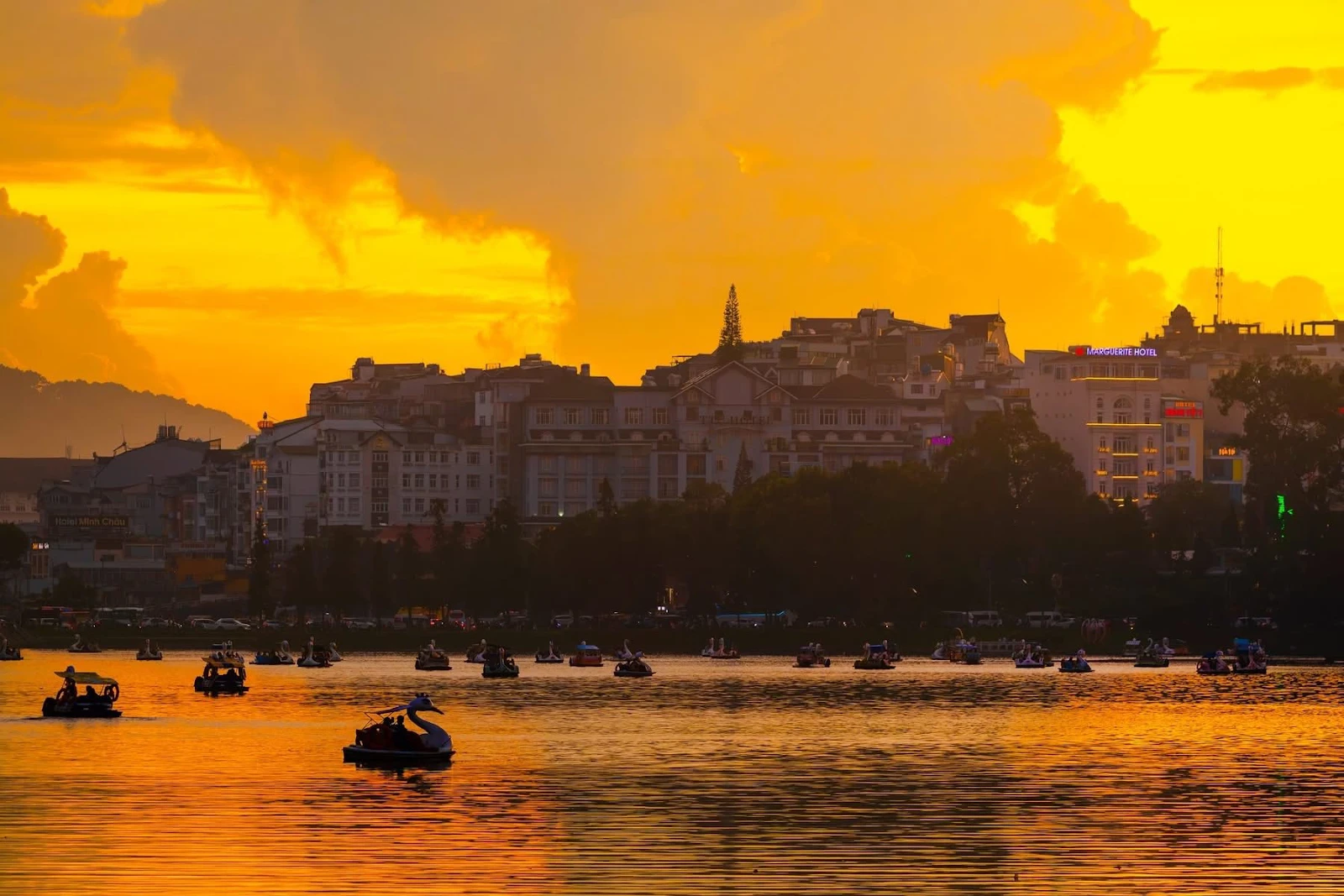 Pedal boating on Xuan Huong Lake at sunset