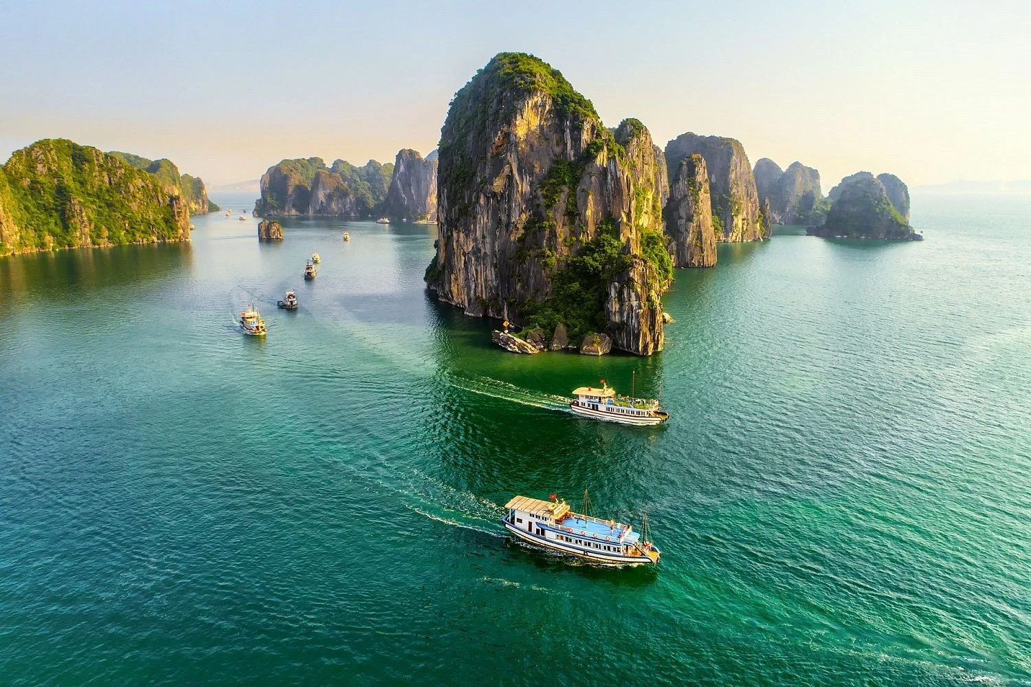 Panoramic view of Ha Long Bay from above with limestone islands and tourist boats