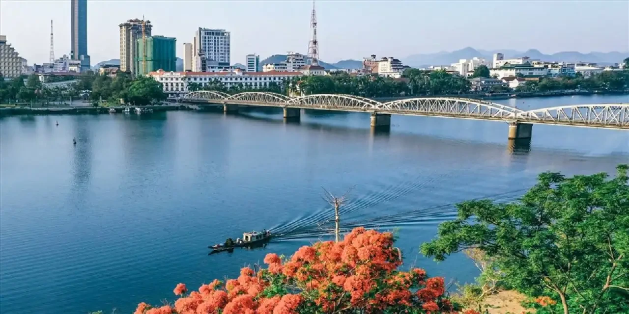 The Perfume River flowing through central Hue with rows of green trees