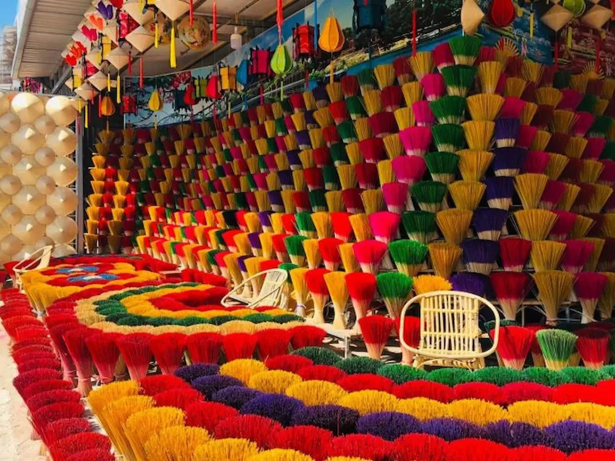 The traditional craft space of Thuy Xuan Incense Village highlighted by vibrant bundles of colorful incense