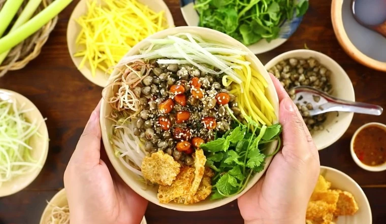 Hue-style Com Hen with stir-fried clams, fresh herbs, and various seasonings