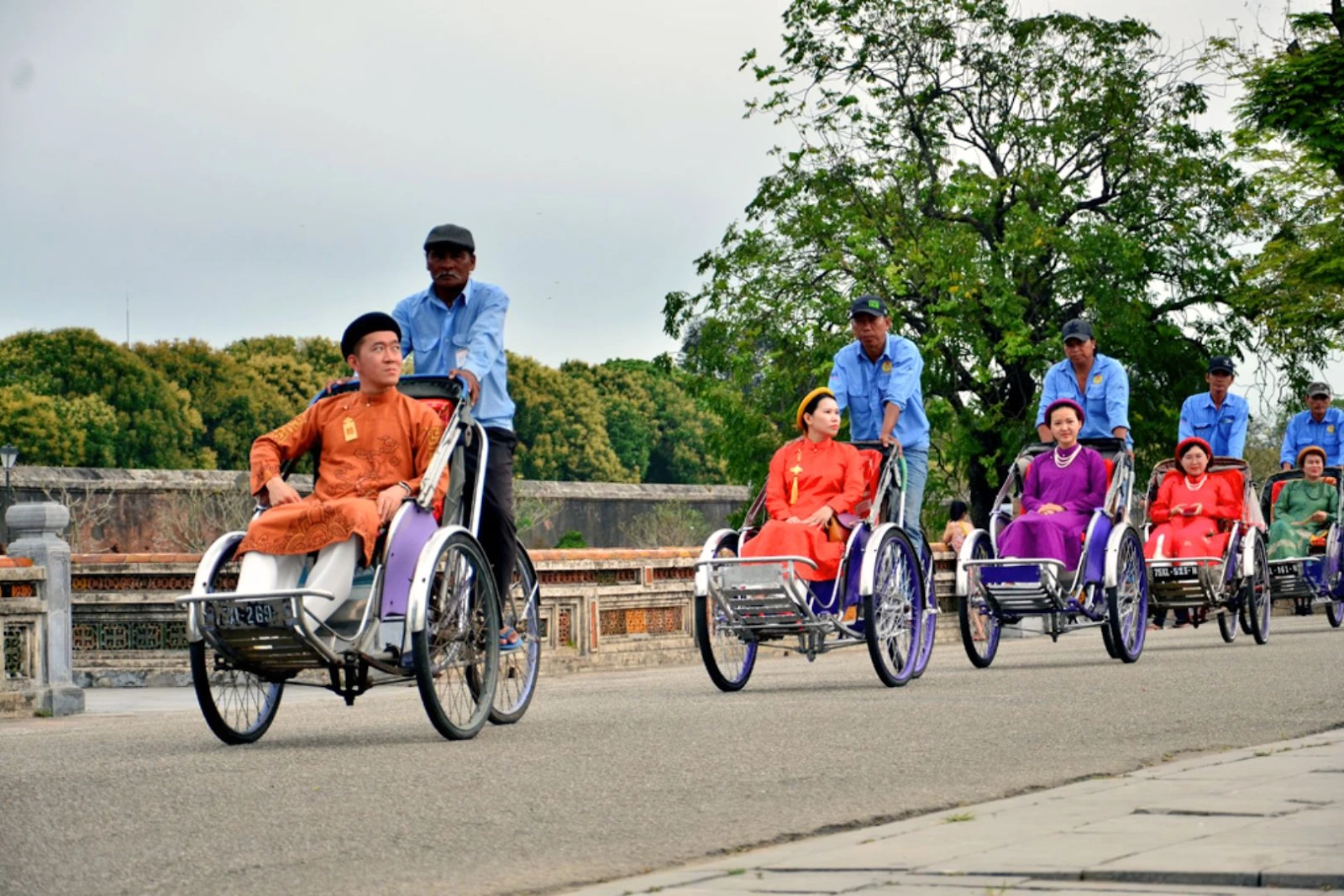 Travelers renting cyclos to explore tourist attractions in Hue City