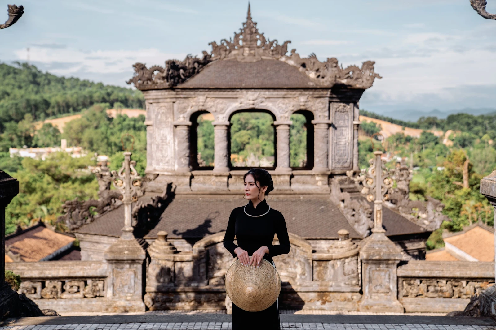 Travelers in traditional ao dai posing for photos at the ancient architectural complex of Khai Dinh Tomb in Hue