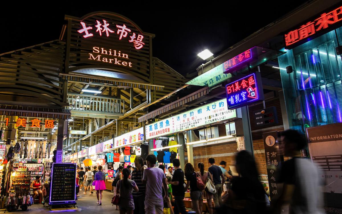 Shilin Market is a bustling place, with neon signs and numerous food and clothing stalls.
