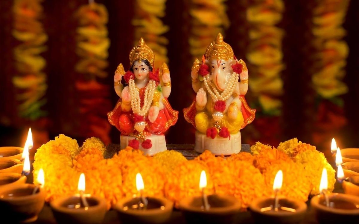 A Diwali worship space with deity statues and candlelight