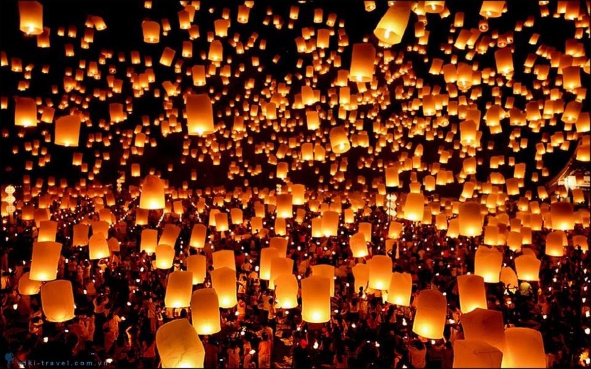 Indian locals release glowing lanterns, transforming the Diwali night into a shimmering spectacle.