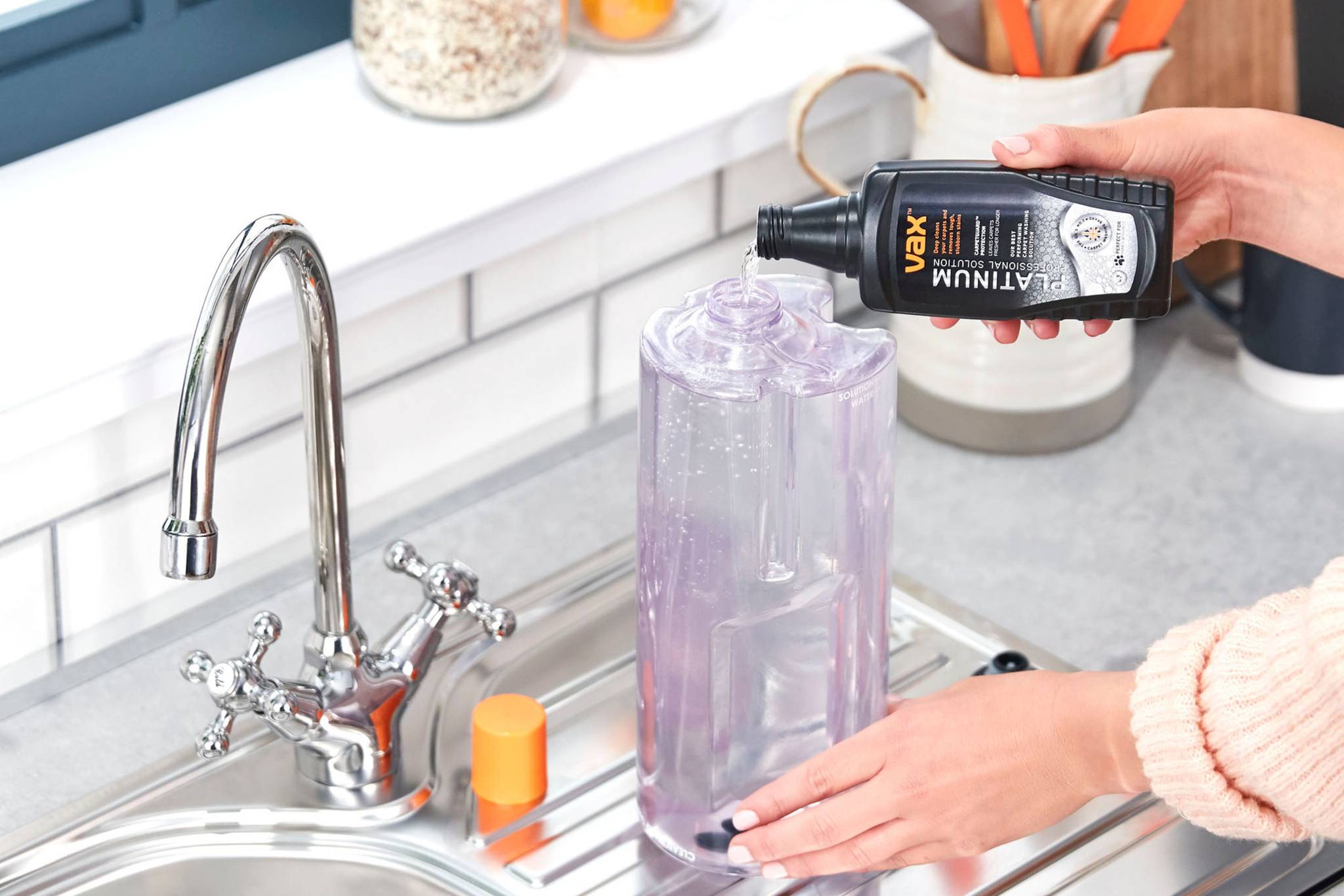 Pouring the Platinum Professional Solution into the solution tank of the VAX Compact Power Carpet Cleaner 