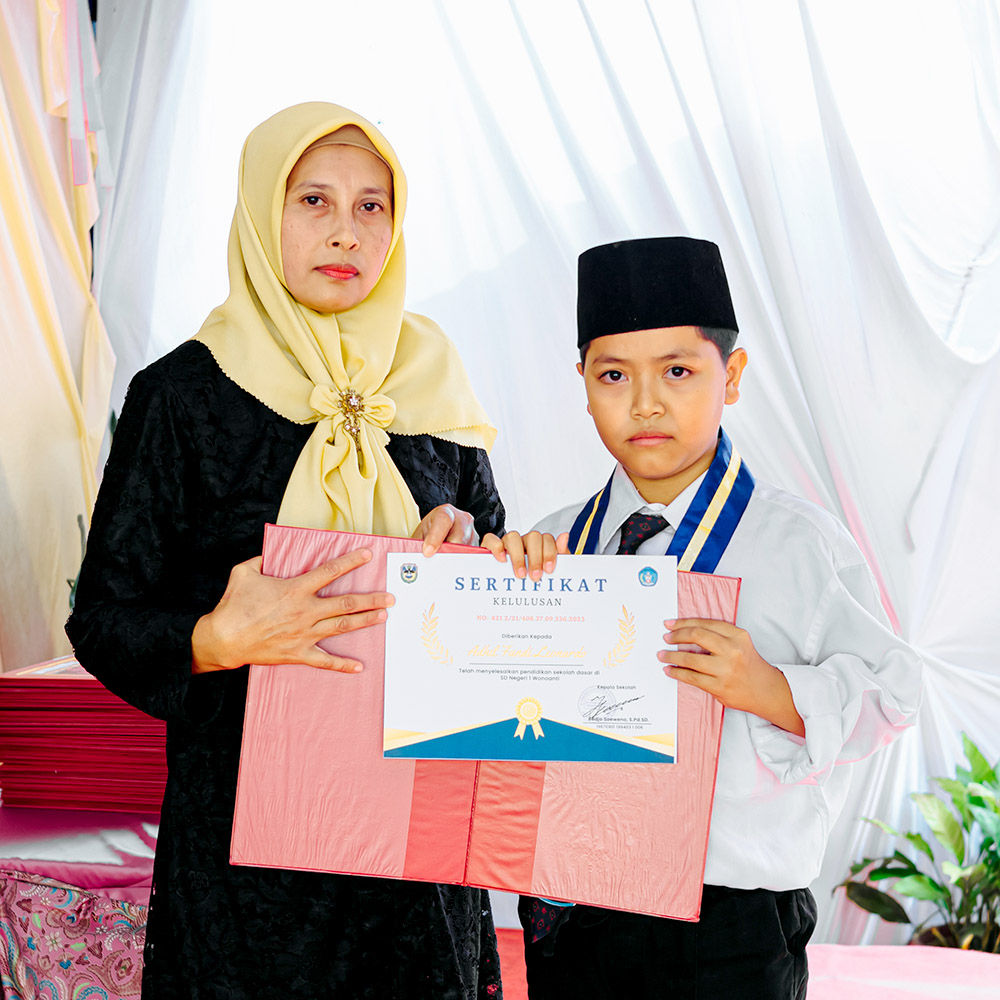 University rector presenting diploma to graduate student on stage with academic procession and faculty members in colorful ceremonial robes seated behind