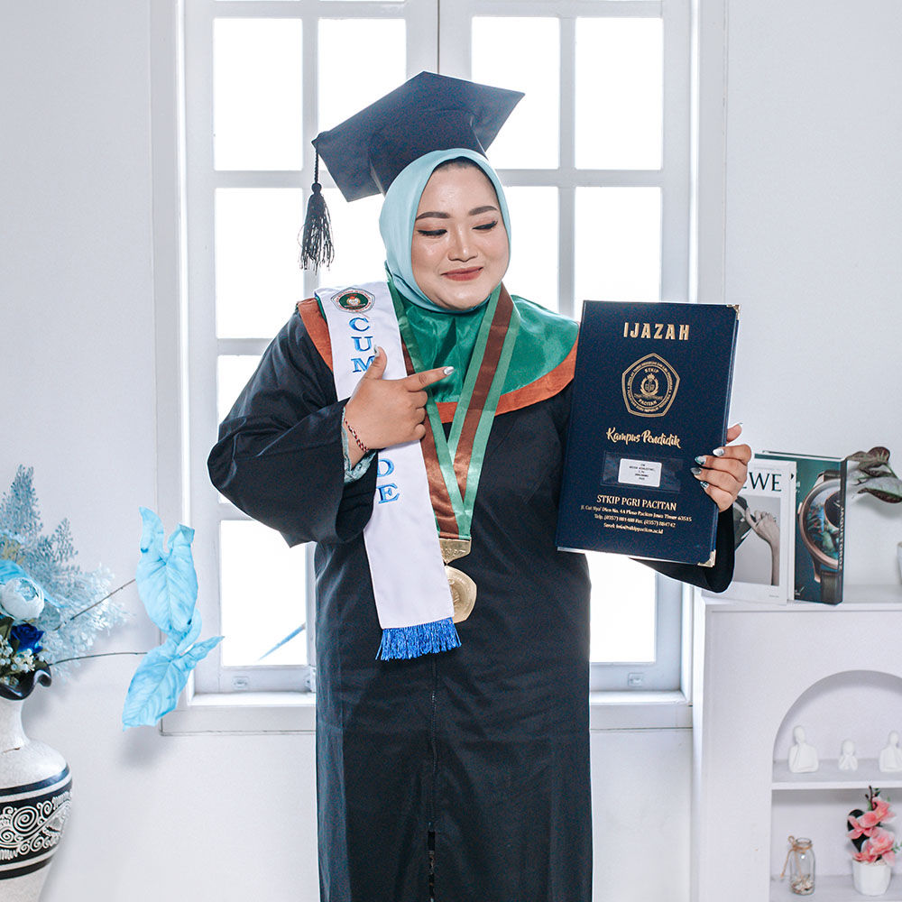 Close up portrait of smiling graduate in black academic regalia holding diploma scroll with golden seal against university building background in natural sunlight