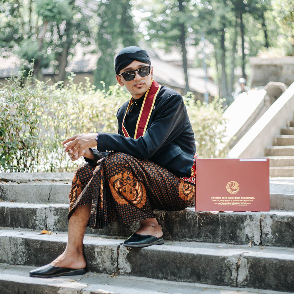 Artistic black and white portrait of graduate holding diploma with thoughtful expression looking upward symbolizing bright future and aspirations with soft lighting