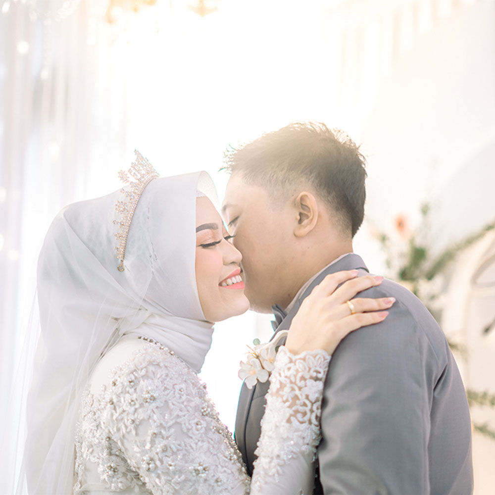 Bride and groom sharing joyful laugh together during candid moment with natural expressions and soft lighting