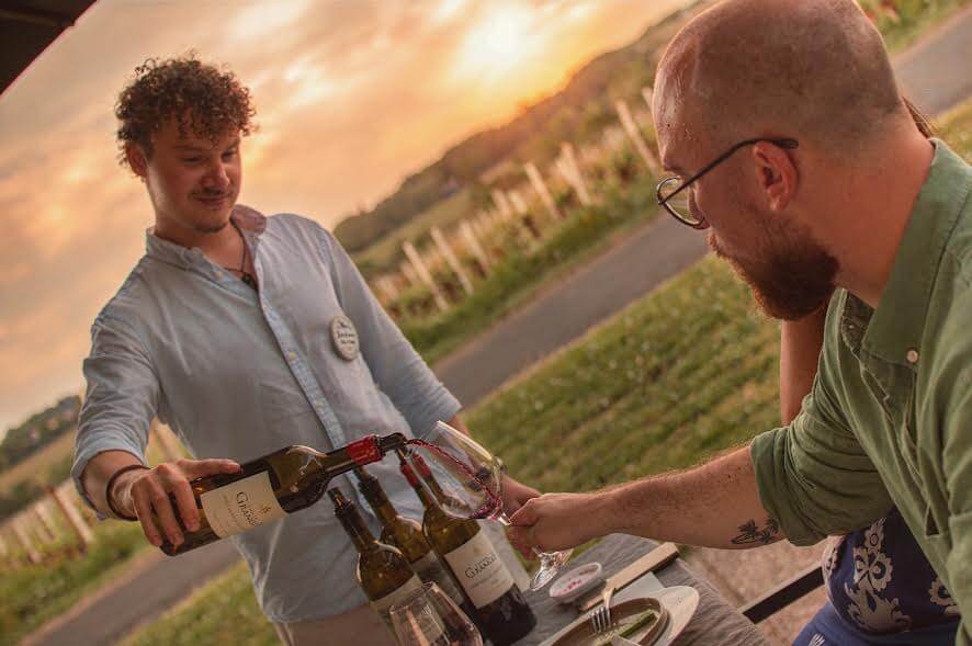 Small group enjoying the sunset view over Saint-Emilion UNESCO village on an evening wine tour