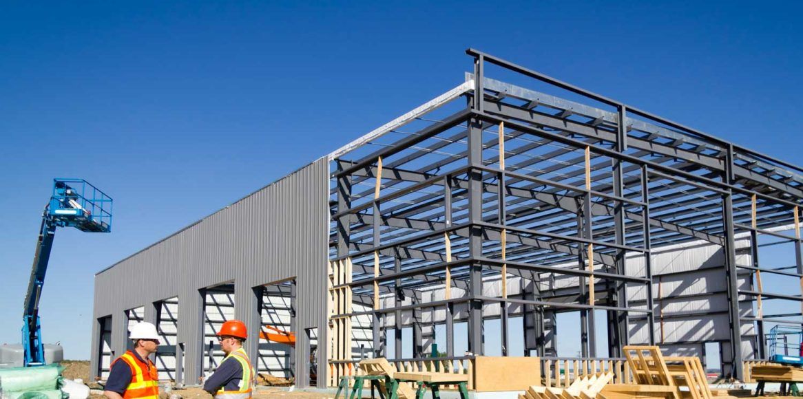 A large commercial warehouse building under a clear sky.