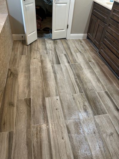Wood-look tile flooring in modern bathroom remodel in Cedar Park, Texas
