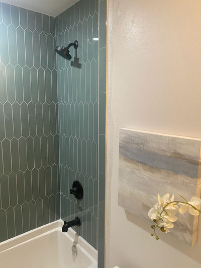Modern bathtub and shower combo with vertical gray hex tile in Georgetown, Texas