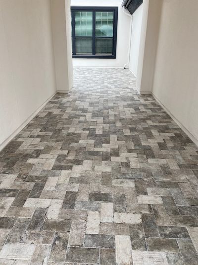 Hallway with gray herringbone tile flooring in Georgetown, Texas