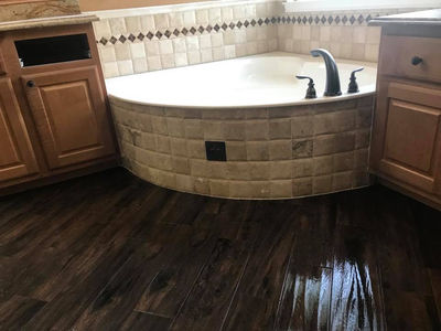 Rustic bathroom remodel with round soaking tub and dark wood floors in Georgetown, Texas