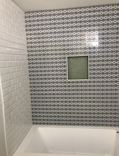 Modern bathtub surround with geometric tile accent wall in Lakeway, Texas