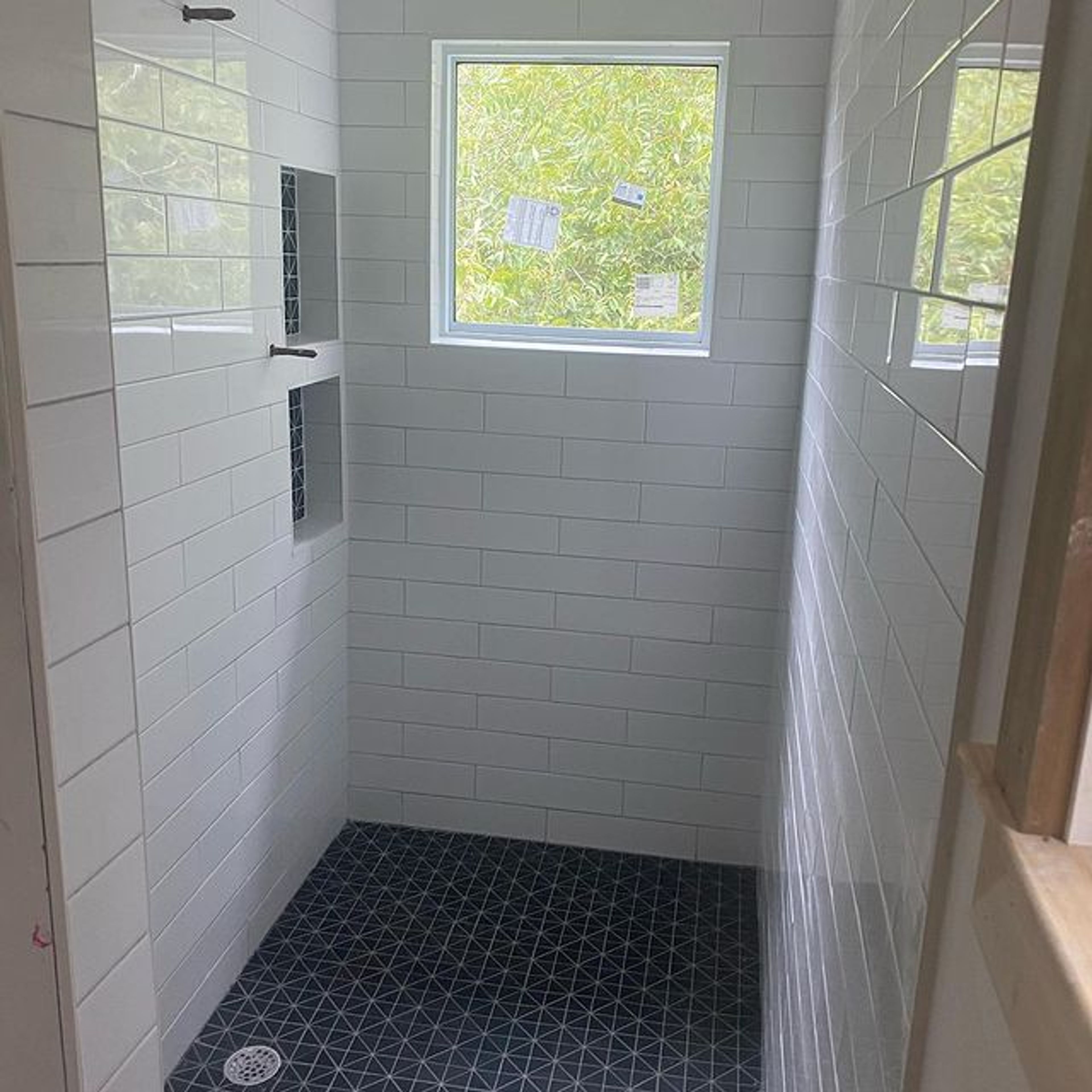 White tile shower with window