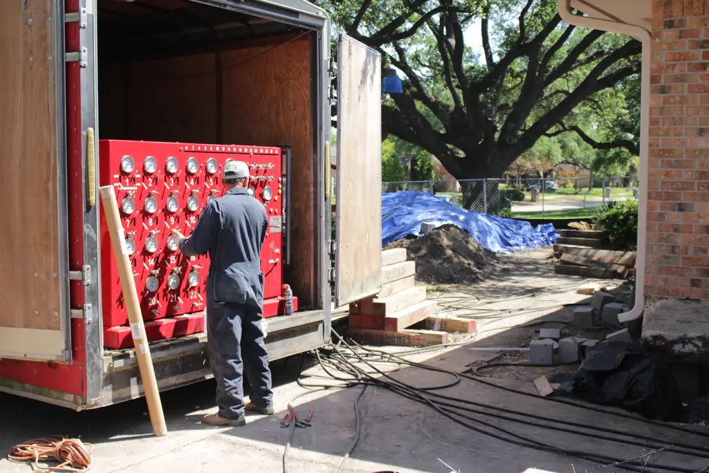 Home elevation Phase II — unified jacking system lifting a house, structural lift from 4 to 24 feet with synchronized hydraulic jacks
