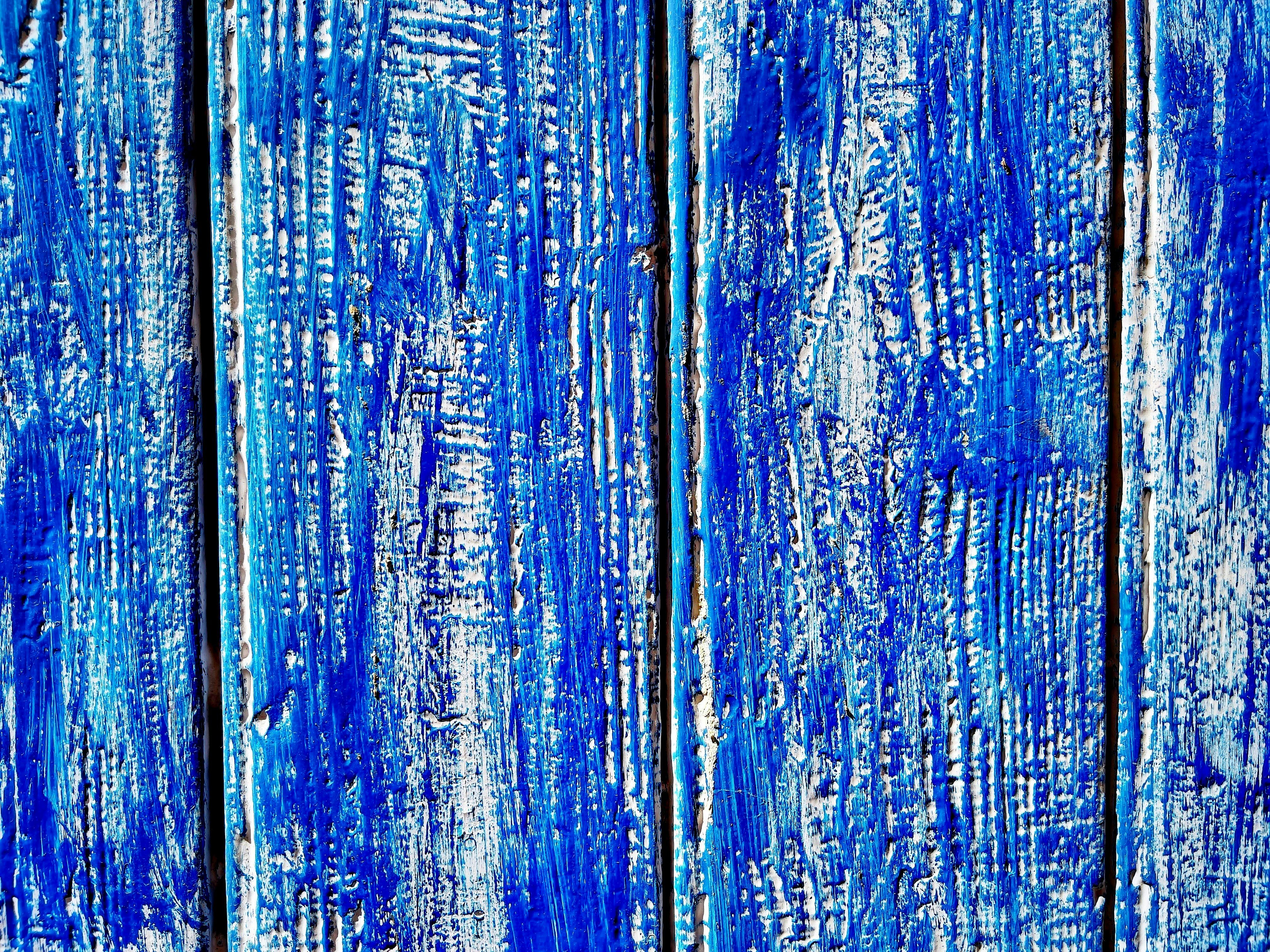 a close up of blue paint on a wooden surface