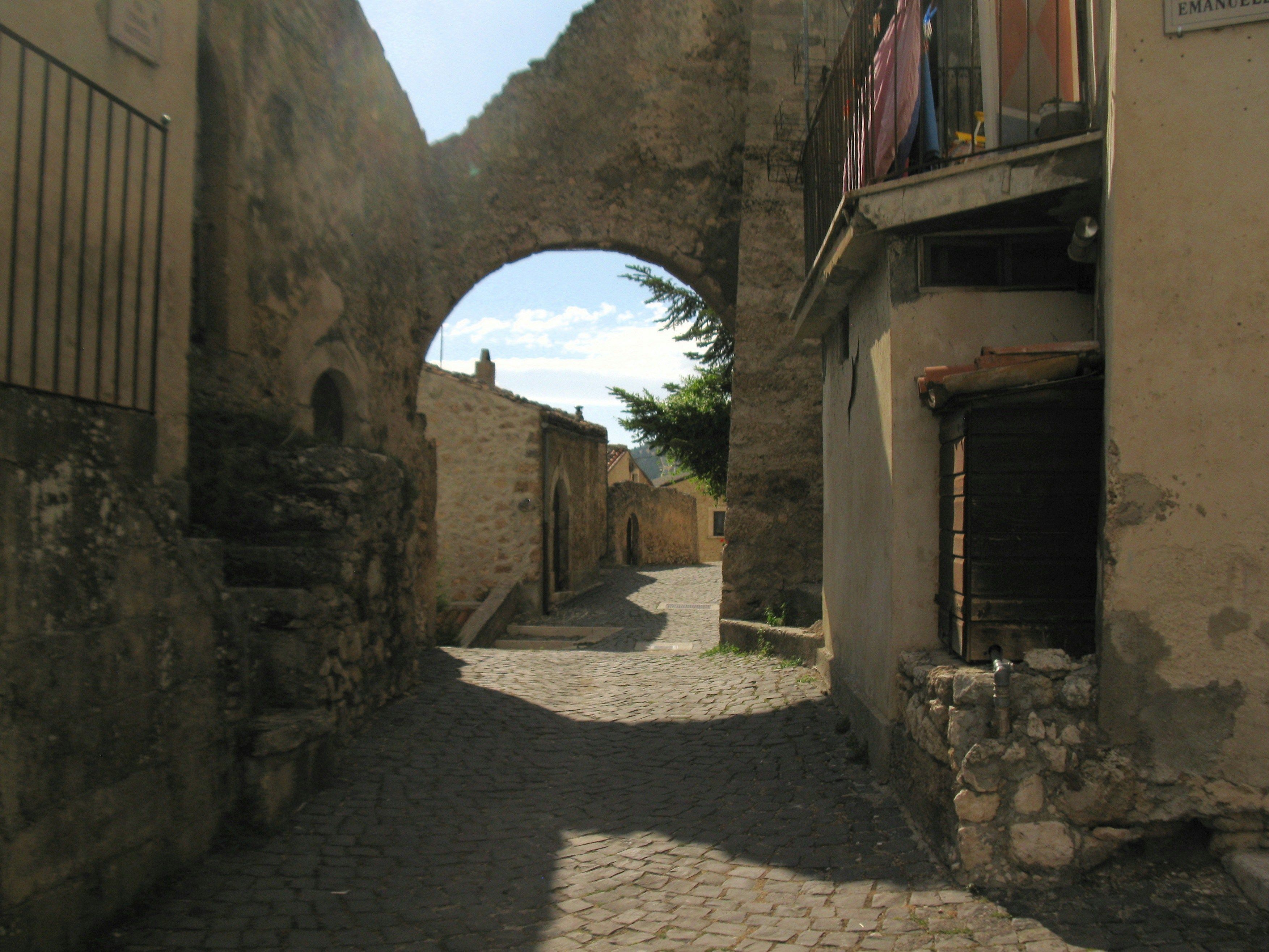 a stone street with buildings on both sides
