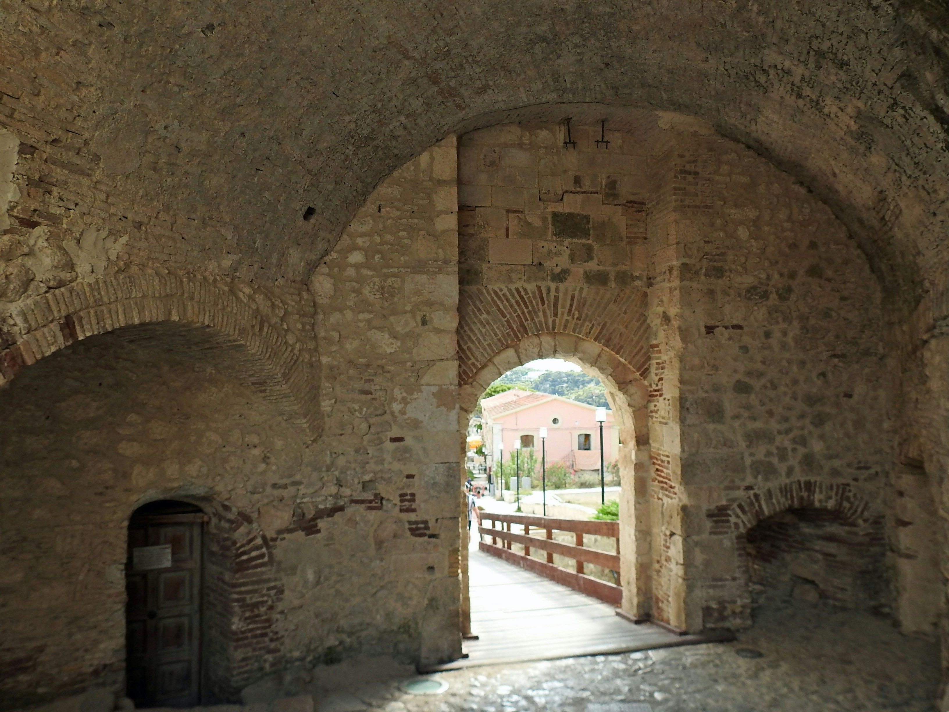 a stone tunnel with a walkway